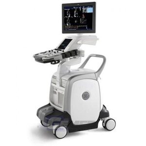 The image shows a medical ultrasound machine on wheels with a monitor displaying an ultrasound scan, indicating its use for medical imaging purposes.
