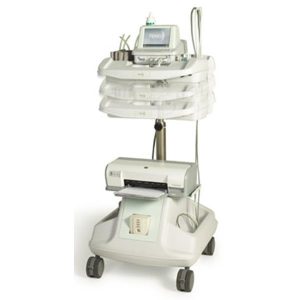 The image shows a medical device on a mobile cart with a monitor displaying information, likely used for patient monitoring or treatment.